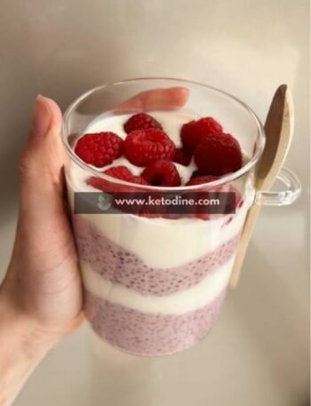 In a medium bowl, combine chia seeds, almond milk, protein powder, and sweetener. Stir over low effort (no heat required) until fully combined and smooth. Let sit for 10–15 minutes at room temperature. Stir again to prevent clumping as seeds begin absorbing liquid. Cover and refrigerate for at least 4 hours or overnight. Texture should be thick and spoonable, not watery. Layer the chilled chia pudding with Greek yogurt in serving glasses. Add fresh raspberries on top for color and freshness. Serve cold. Keto tip: Always check your protein powder label for hidden sugars.