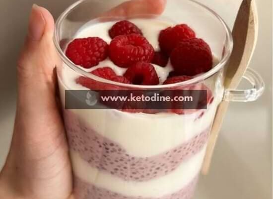 In a medium bowl, combine chia seeds, almond milk, protein powder, and sweetener. Stir over low effort (no heat required) until fully combined and smooth. Let sit for 10–15 minutes at room temperature. Stir again to prevent clumping as seeds begin absorbing liquid. Cover and refrigerate for at least 4 hours or overnight. Texture should be thick and spoonable, not watery. Layer the chilled chia pudding with Greek yogurt in serving glasses. Add fresh raspberries on top for color and freshness. Serve cold. Keto tip: Always check your protein powder label for hidden sugars.