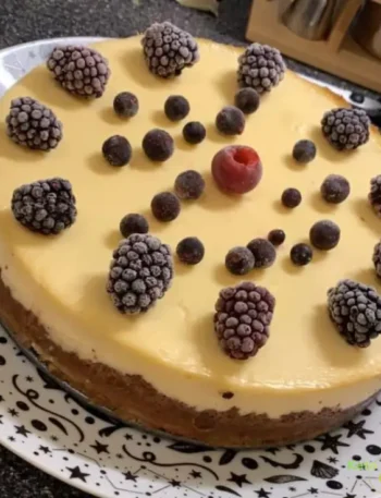 homemade cheesecake decorated with frozen berries