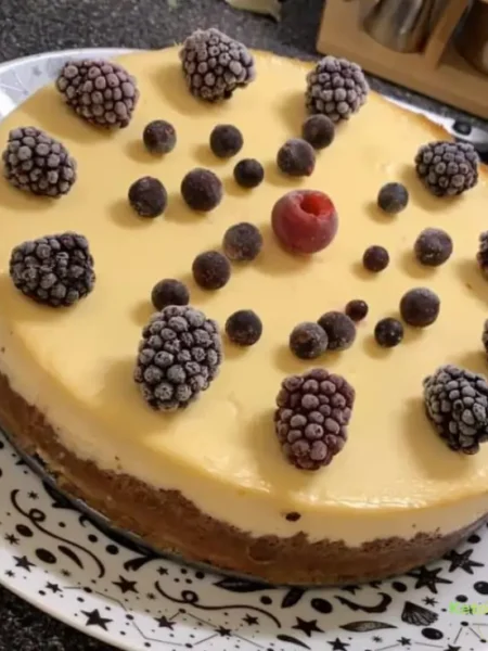 homemade cheesecake decorated with frozen berries